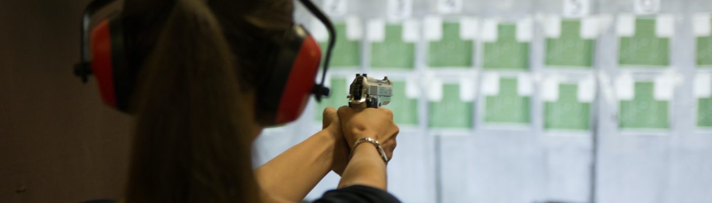 woman-aiming-gun-in-shooting-range.jpg